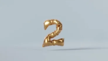 A golden balloon in the shape of the number 2